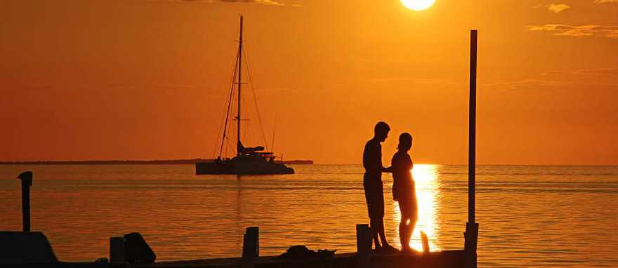 Couple enjoying a romantic sunset in Belize Couple enjoying a romantic sunset in Belize