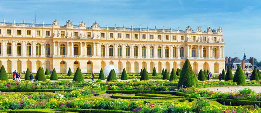 Lush green garden and Versailles building in France Lush green garden and Versailles building in France