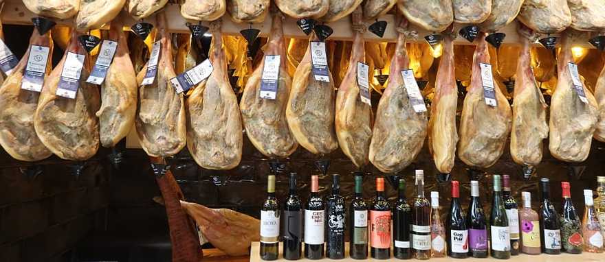 Jamon and wine for sale at a market in Spain. Jamon and wine for sale at a market in Spain.