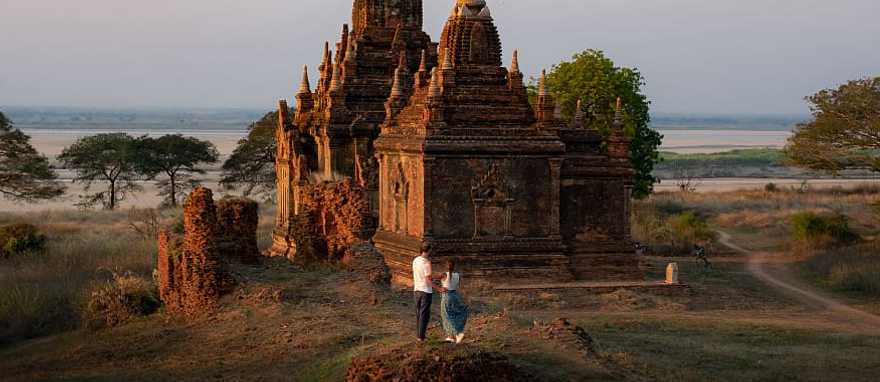 Couple enjoying view of a buddhist temple in Myanmar Couple enjoying view of a buddhist temple in Myanmar