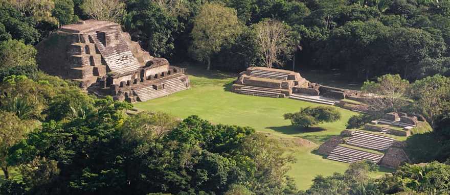 Mayan temples rise above the treetops like ancient skyscrapers. Mayan temples rise above the treetops like ancient skyscrapers.
