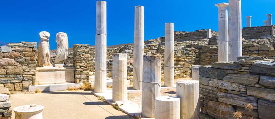 Alluring Family Vacation to Greece: Athens, Mykonos & Santorini Ancient ruins in the island of Delos in Cyclades, one of the most important mythological, historical and archaeological sites in Greece