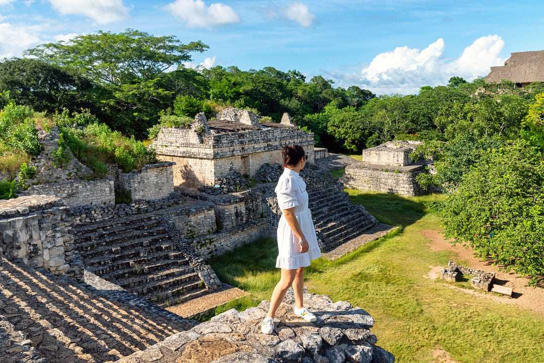 Woman looking out at Mayan ruins in Yucatan, Mexico