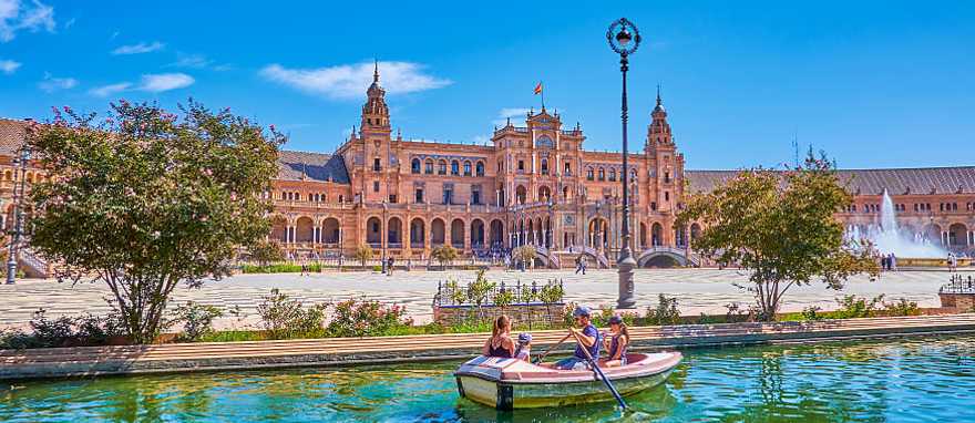 Plaza de Espana in Seville, Spain Family boating in the canal at Plaza de Espana in Seville, Spain