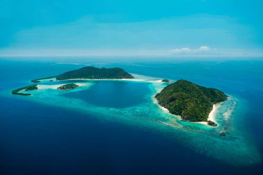 Tropical island surrounded by crystal-clear turquoise waters.