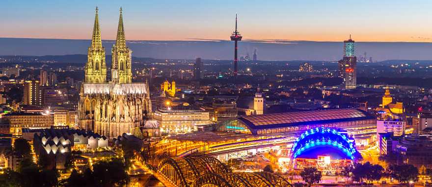 Cologne, Germany Night view of the Cologne Cathedral and the Hohenzollern bridge with the Rhine river in Germany.