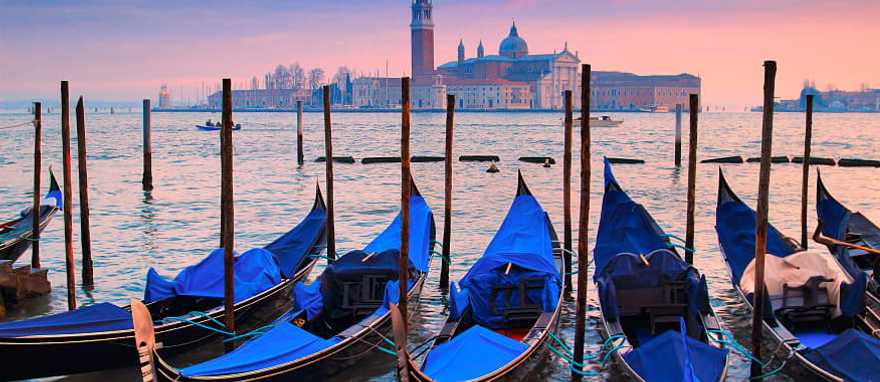 Gondolas on Venice canal at sunset in Italy Gondolas on Venice canal at sunset in Italy