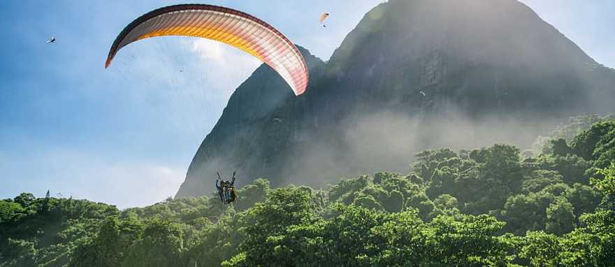 Couple on a romantic paragliding flight over the coast of Brazil Couple on a romantic paragliding flight over the coast of Brazil