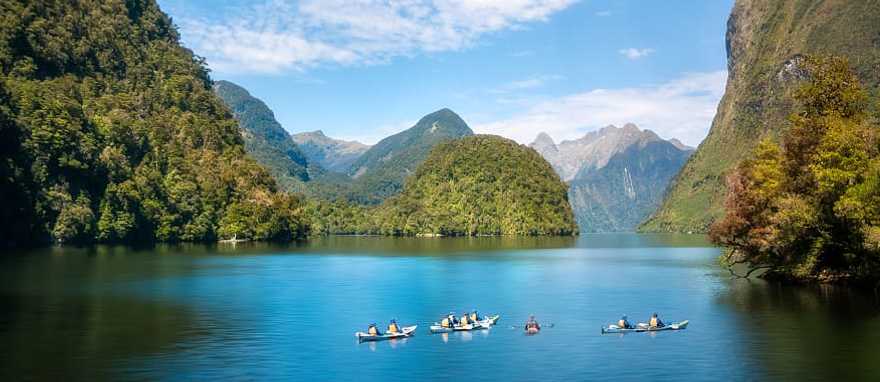Family kayaking in the Doubtful Sound in New Zealand Family kayaking in the Doubtful Sound in New Zealand