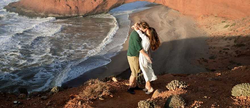 Couple at Legzira Beach near Agadir, Morocco Couple at Legzira Beach near Agadir, Morocco