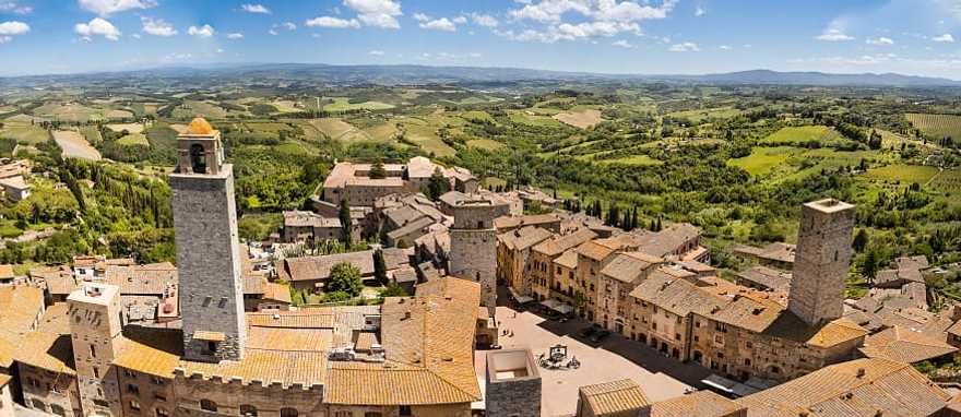 San Gimignano in Tuscany, Italy San Gimignano surrounded by the green rolling hills and vineyards of Tuscany, Italy