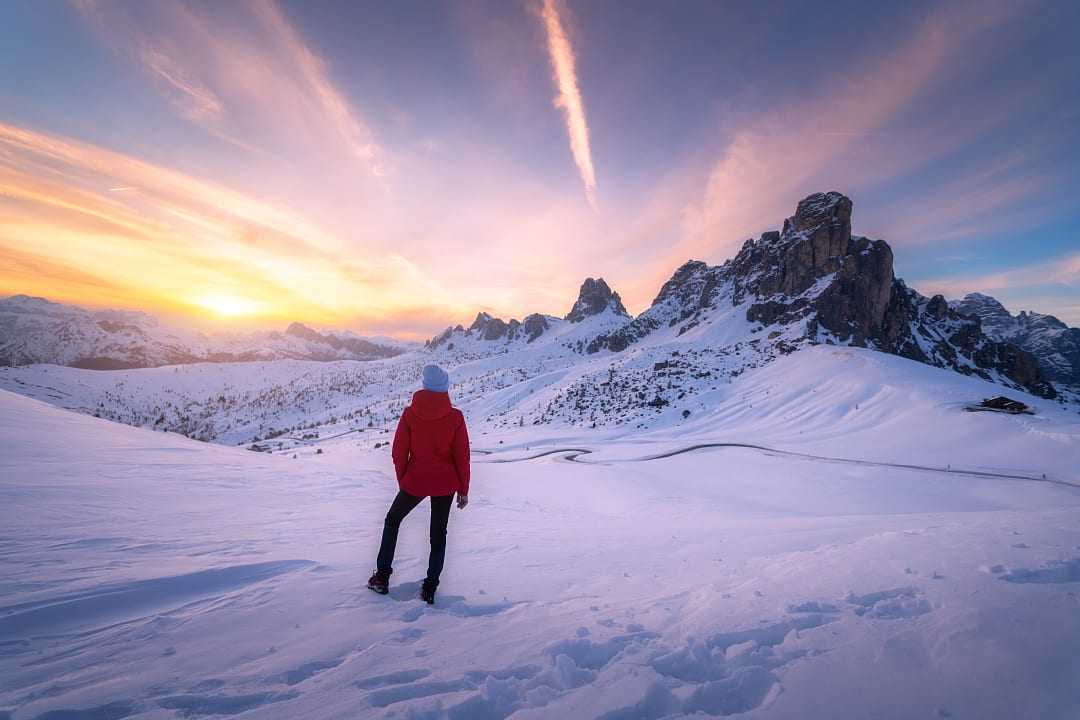 Woman hiking in the Dolomites during winter