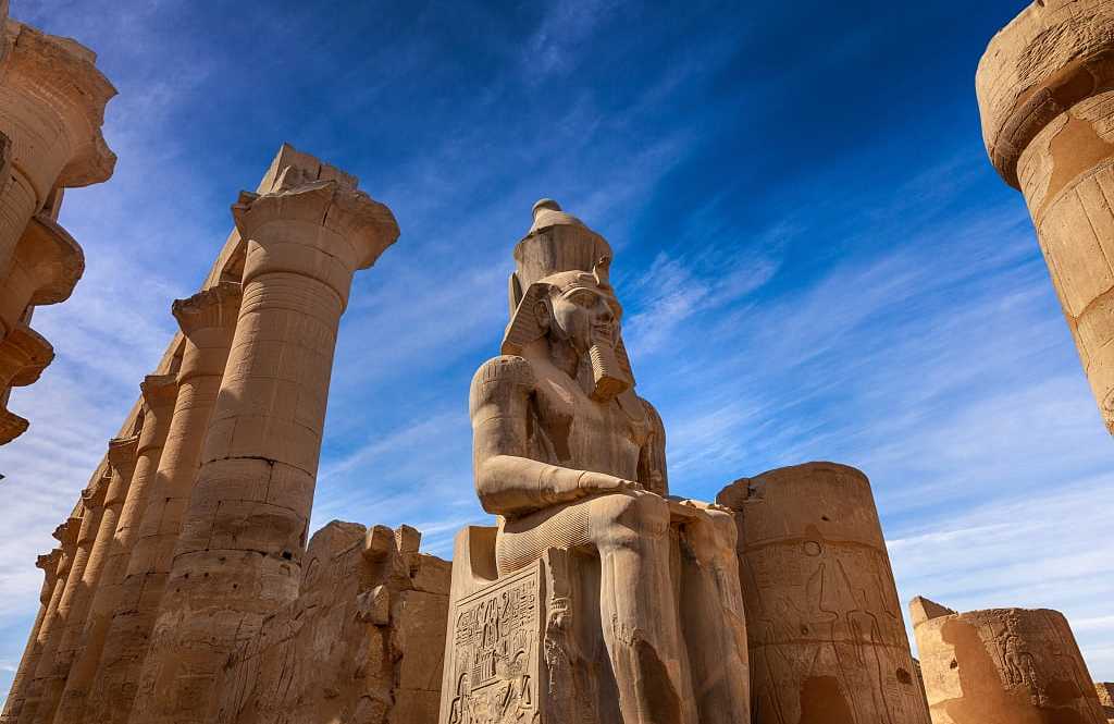 Karnak Temple in Luxor, Egypt Stone statue of Ramses II at Karnak Temple in Luxor, Egypt