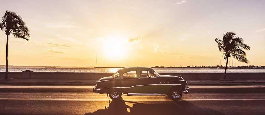 Classic car driving along the Malecon in Havana, Cuba. Classic car driving along the Malecon in Havana, Cuba.