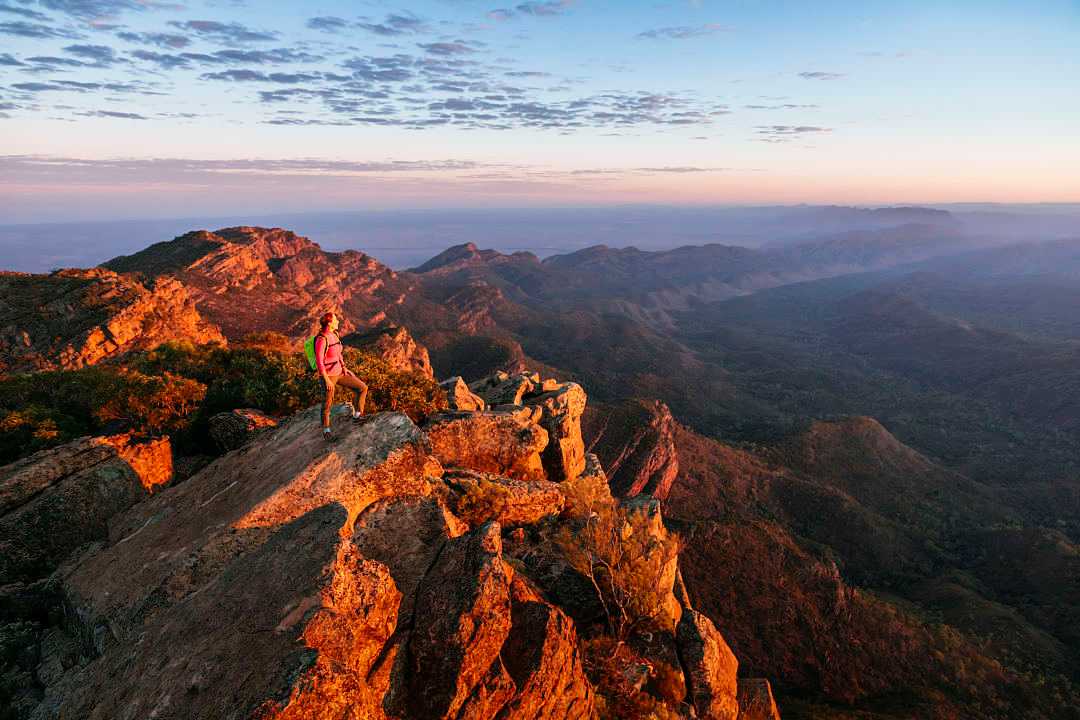 Woman hiking St Mary Peak in Flinders Ranges National Park, Australia