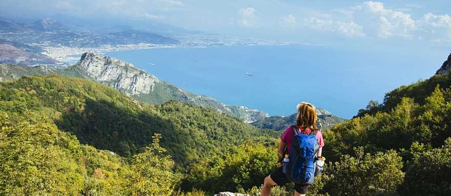 Hiker admiring the view along the Path of the Gods in the Amalfi Coast, Italy Hiker admiring the view along the Path of the Gods in the Amalfi Coast, Italy