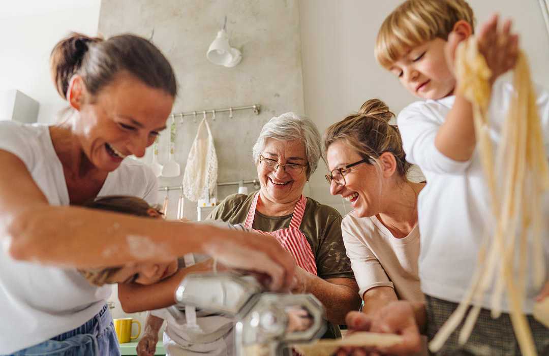 Private cooking class in Italy Family learning how to make pasta