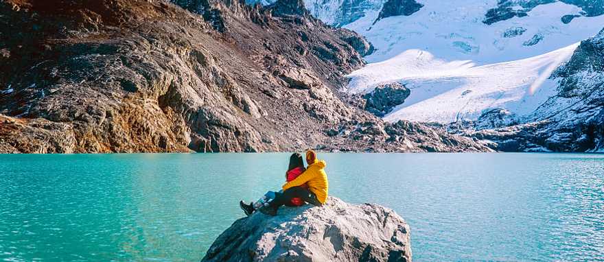 Couple admiring mount Fitzroy in the Argentinian Patagonia Couple admiring mount Fitzroy in the Argentinian Patagonia