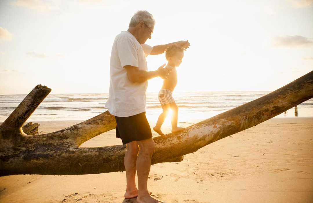 Grandfather with his grandson on the beach in Latin America Grandfather with his grandson on the beach in Latin America