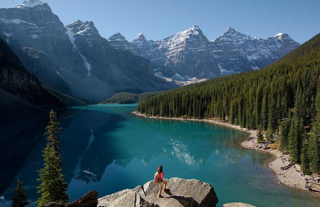 Moraine Lake in Banff National Park, Canada Woman hiking at Moraine Lake in Banff National Park, Canada